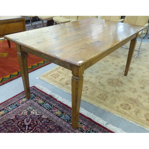 327 - A modern oak table, raised on square, tapered legs  30