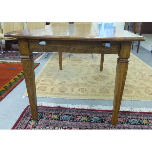 327 - A modern oak table, raised on square, tapered legs  30