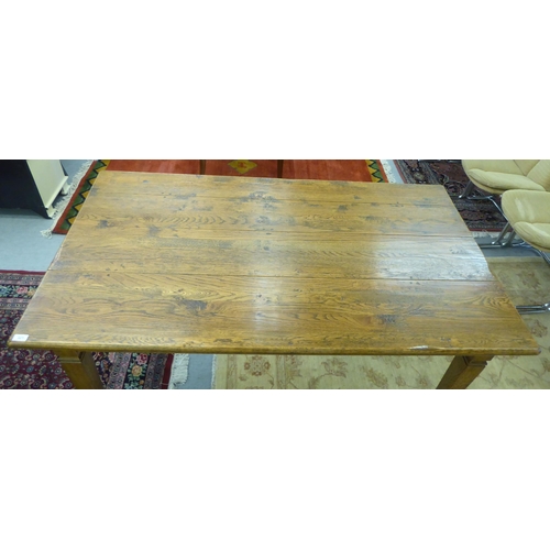 327 - A modern oak table, raised on square, tapered legs  30