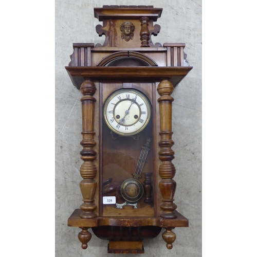 328 - A late 19thC stained beech cased wall timepiece; the movement faced by a Roman dial  32