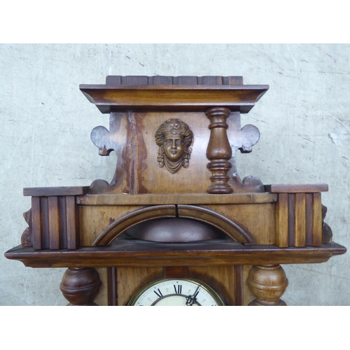 328 - A late 19thC stained beech cased wall timepiece; the movement faced by a Roman dial  32