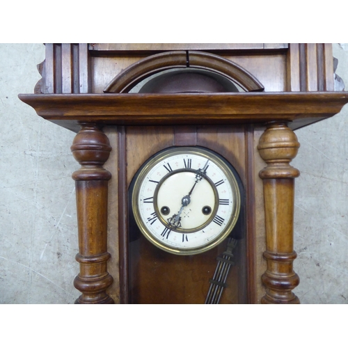 328 - A late 19thC stained beech cased wall timepiece; the movement faced by a Roman dial  32