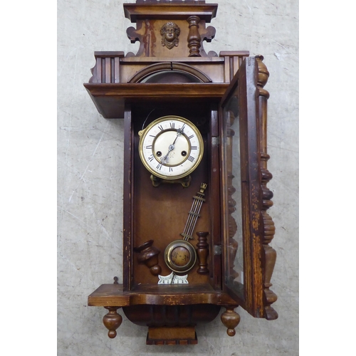 328 - A late 19thC stained beech cased wall timepiece; the movement faced by a Roman dial  32