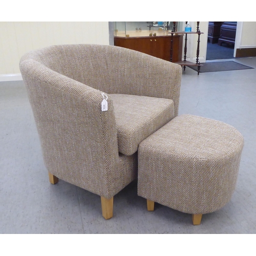 333 - A modern three tone textured, fabric upholstered tub chair and footstool, raised on tapered forelegs