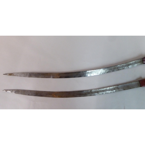 338 - Two North African swords, each with a hide scabbard  24