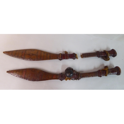 338 - Two North African swords, each with a hide scabbard  24