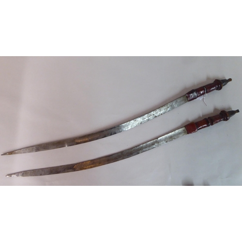 338 - Two North African swords, each with a hide scabbard  24