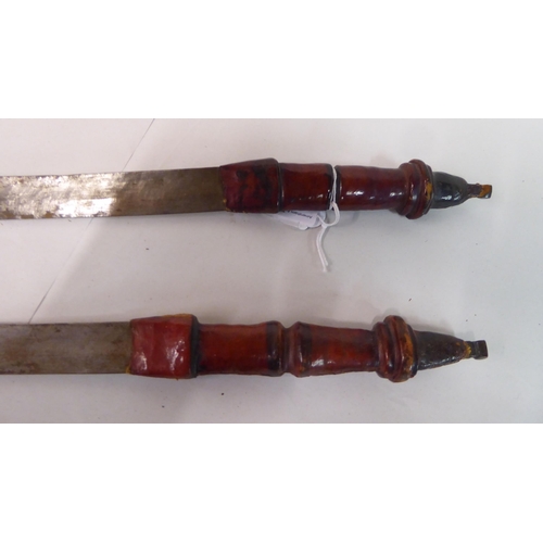 338 - Two North African swords, each with a hide scabbard  24