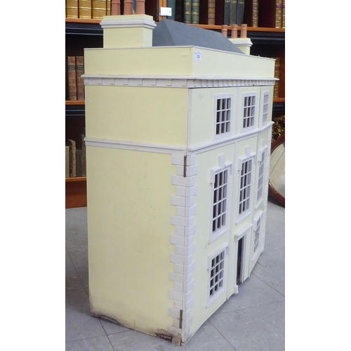 339 - A 20thC Georgian design, yellow and white painted, three storey doll's townhouse, the double opening... 