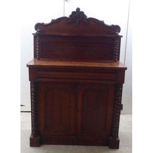 340 - A late Victorian mahogany chiffonier with a raised back, over a drawer and two panelled doors, on a ... 