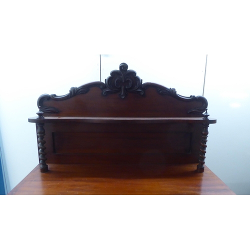 340 - A late Victorian mahogany chiffonier with a raised back, over a drawer and two panelled doors, on a ... 