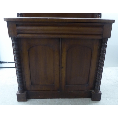 340 - A late Victorian mahogany chiffonier with a raised back, over a drawer and two panelled doors, on a ... 