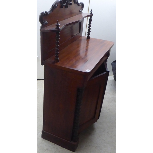 340 - A late Victorian mahogany chiffonier with a raised back, over a drawer and two panelled doors, on a ... 