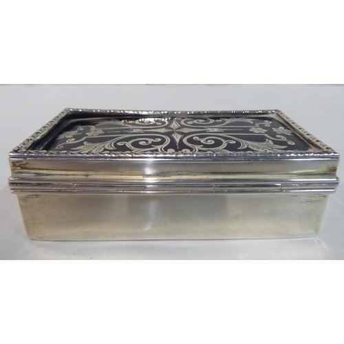 35 - A silver ring box with straight sides, a hinged lid and boulle worked ornament  marks rubbed  3.5