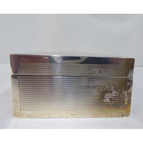 37 - A silver cigarette box with straight sides, a hinged lid and engine turned decoration  Birmingham 19... 