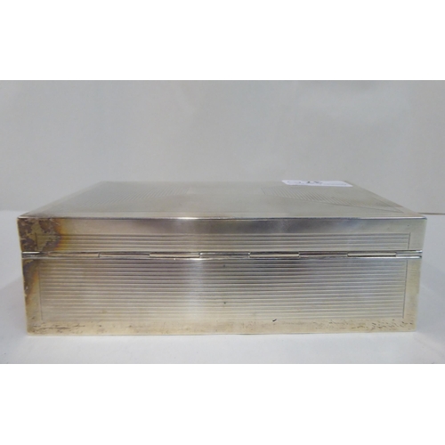 37 - A silver cigarette box with straight sides, a hinged lid and engine turned decoration  Birmingham 19... 