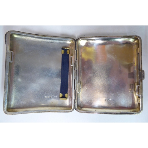 45 - A silver folding cigarette case, on a button clasp, decorated in Art Nouveau taste, coloured enamel ... 