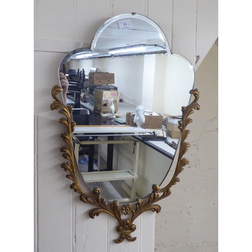 71 - A 20thC mirror, the shaped bevelled plate, set in a Georgian style cast metal mount  29