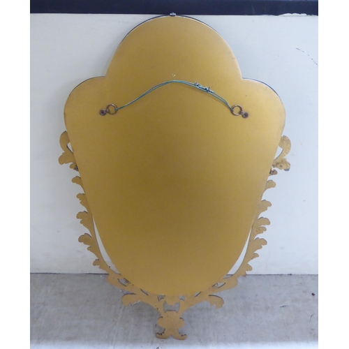 71 - A 20thC mirror, the shaped bevelled plate, set in a Georgian style cast metal mount  29