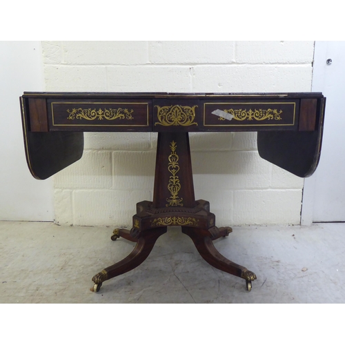 73 - A Regency brass inlaid rosewood sofa table with two frieze drawers, raised on a column and splayed q... 