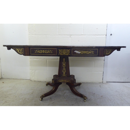 73 - A Regency brass inlaid rosewood sofa table with two frieze drawers, raised on a column and splayed q... 