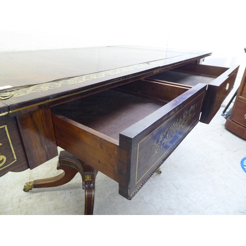 73 - A Regency brass inlaid rosewood sofa table with two frieze drawers, raised on a column and splayed q... 