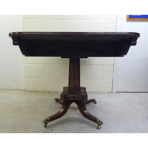 73 - A Regency brass inlaid rosewood sofa table with two frieze drawers, raised on a column and splayed q... 