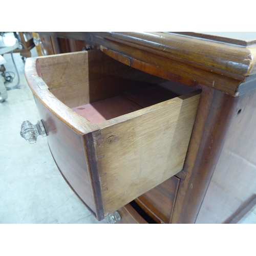 78 - A late Victorian one-piece mahogany bow breakfront, six drawer kneehole desk, on a plinth  29