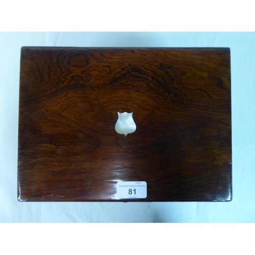 81 - A late Victorian rosewood vanity box with a hinged lid, enclosing a part-fitted interior and a base ... 