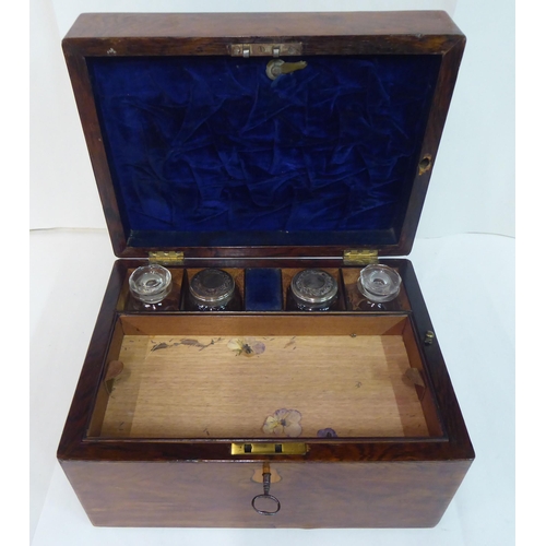 81 - A late Victorian rosewood vanity box with a hinged lid, enclosing a part-fitted interior and a base ... 