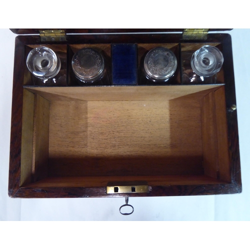 81 - A late Victorian rosewood vanity box with a hinged lid, enclosing a part-fitted interior and a base ... 