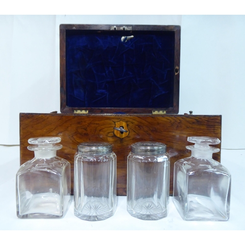 81 - A late Victorian rosewood vanity box with a hinged lid, enclosing a part-fitted interior and a base ... 