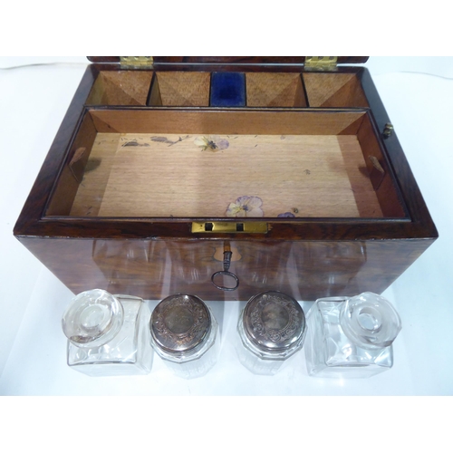 81 - A late Victorian rosewood vanity box with a hinged lid, enclosing a part-fitted interior and a base ... 