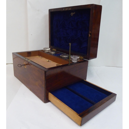 81 - A late Victorian rosewood vanity box with a hinged lid, enclosing a part-fitted interior and a base ... 