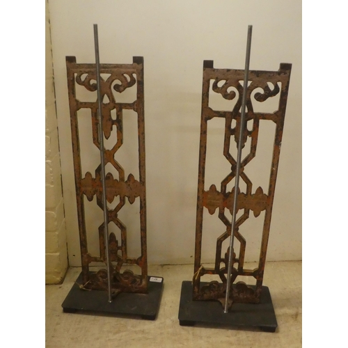 97 - A pair of modern cast iron stands, on a plinth  28