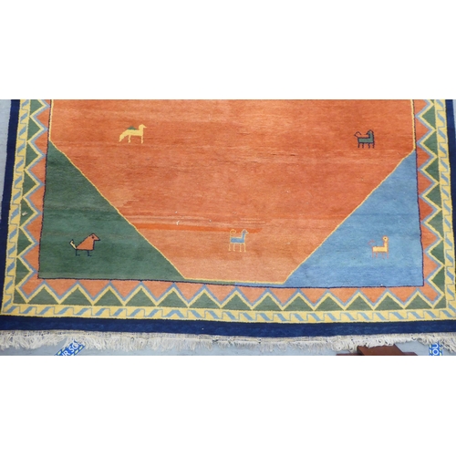 99 - A modern woollen rug, decorated with animals on a two-tone orange/red ground  102