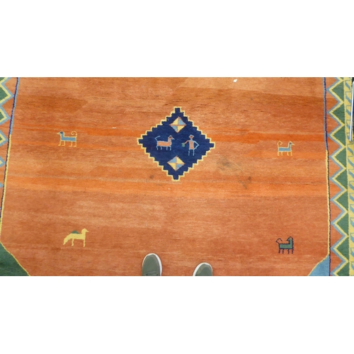 99 - A modern woollen rug, decorated with animals on a two-tone orange/red ground  102