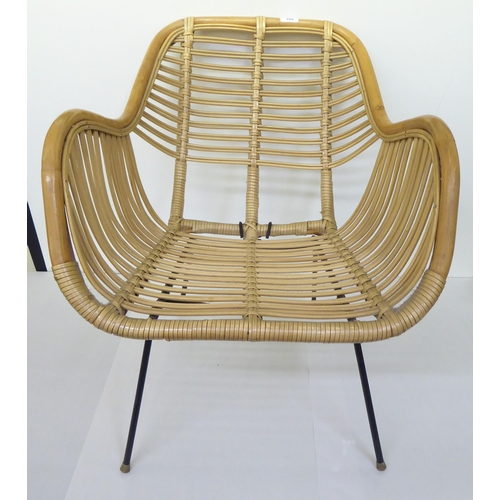 108 - A mid century bamboo and woven cane chair, raised on wrought metal legs