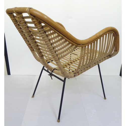 108 - A mid century bamboo and woven cane chair, raised on wrought metal legs