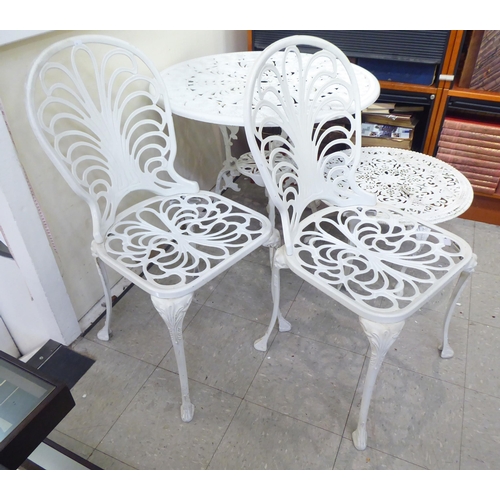 114 - A modern white painted aluminium garden table, raised on splayed legs  26