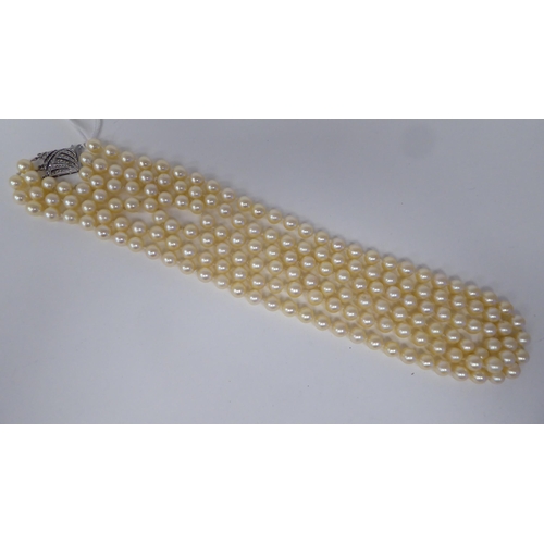 119 - A three row pearl necklace, on a Sterling silver and marcasite bayonet clasp