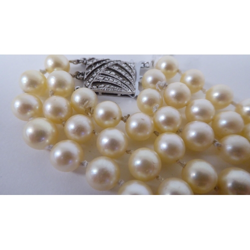 119 - A three row pearl necklace, on a Sterling silver and marcasite bayonet clasp