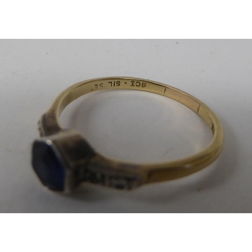 129 - A 9ct gold and white metal ring, set with a central, hexagonal sapphire