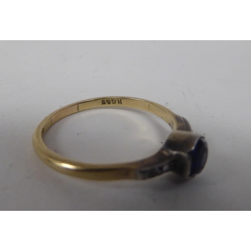 129 - A 9ct gold and white metal ring, set with a central, hexagonal sapphire