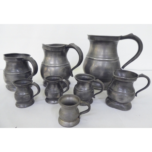 136 - A matched set of seven early 20thC pewter measuring jugs  largest 6.5