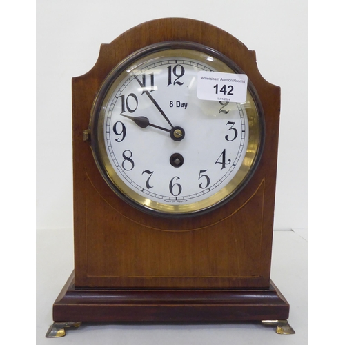 142 - An Edwardian mahogany cased mantel timepiece; the 8 day movement faced by an enamelled Roman dial&nb... 