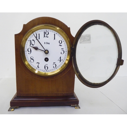 142 - An Edwardian mahogany cased mantel timepiece; the 8 day movement faced by an enamelled Roman dial&nb... 