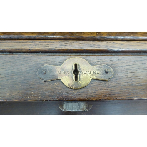 15 - A 1930s oak roll top desk with twin pedestals, comprising an arrangement of eight drawers, raised on... 