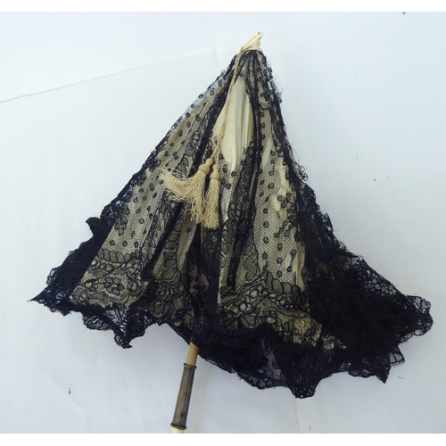 159 - A mixed lot: to include a late Victorian parasol with a folding carved bone handle