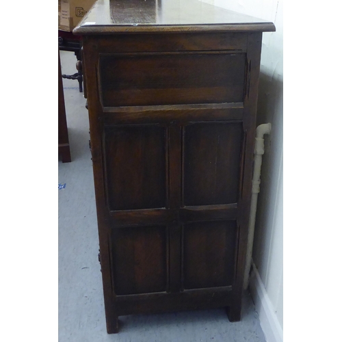 17 - A modern oak sideboard with two drawers and two panelled doors, raised on block feet  34